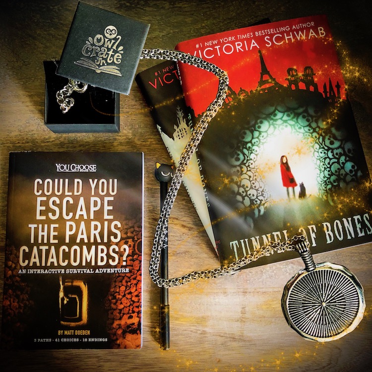 OwlCrate Jr. Tunnel of Bones book and necklace
